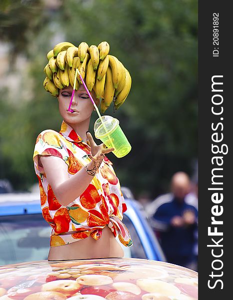 A doll with a bunch of banana on the head. A doll with a bunch of banana on the head