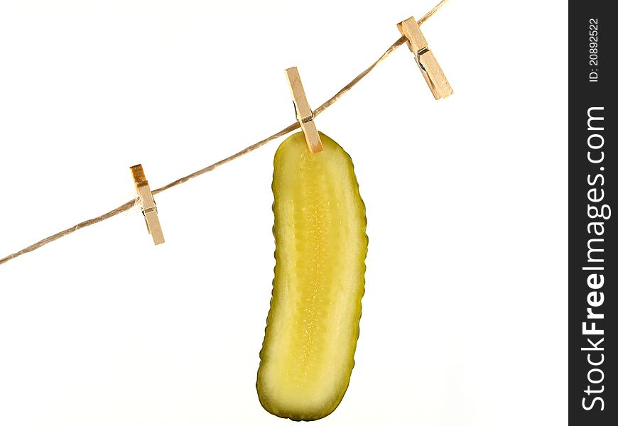 Pickle slices hang out to dry isolated on white background. Pickle slices hang out to dry isolated on white background