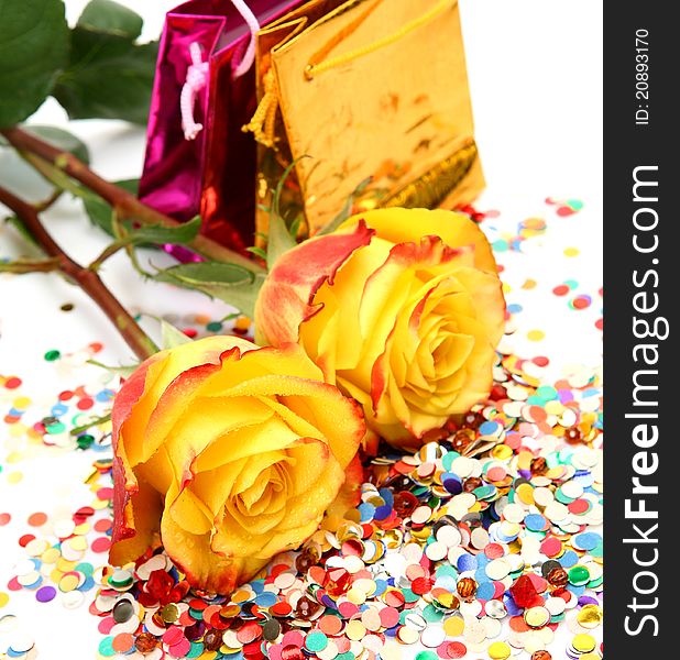 Yellow roses and confetti on a white background