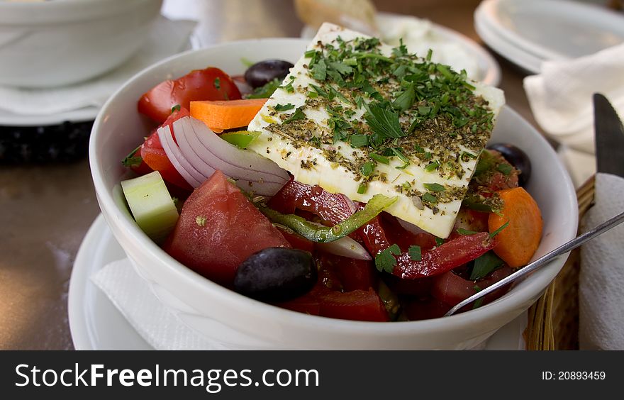 Greek salad with fetta, tomato, cucumber, feta, olives, pepper, carrots and lime. Greek salad with fetta, tomato, cucumber, feta, olives, pepper, carrots and lime