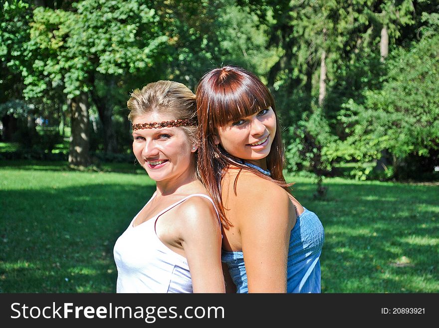 Two beautiful happy sisters outdoors. Two beautiful happy sisters outdoors