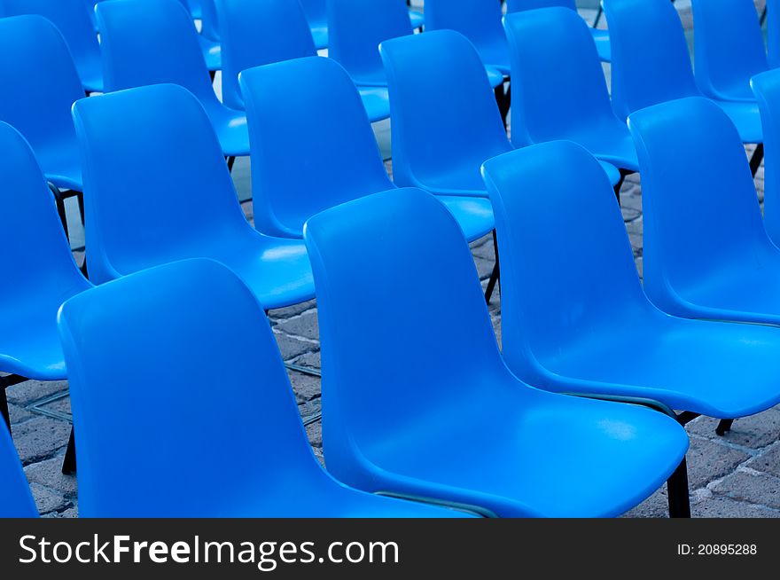 Blue chairs, outdoor in a public place, evenly distributes in rows. Blue chairs, outdoor in a public place, evenly distributes in rows.