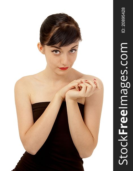 Beautiful brunette girl wearing a black dress standing on the floor on a white background