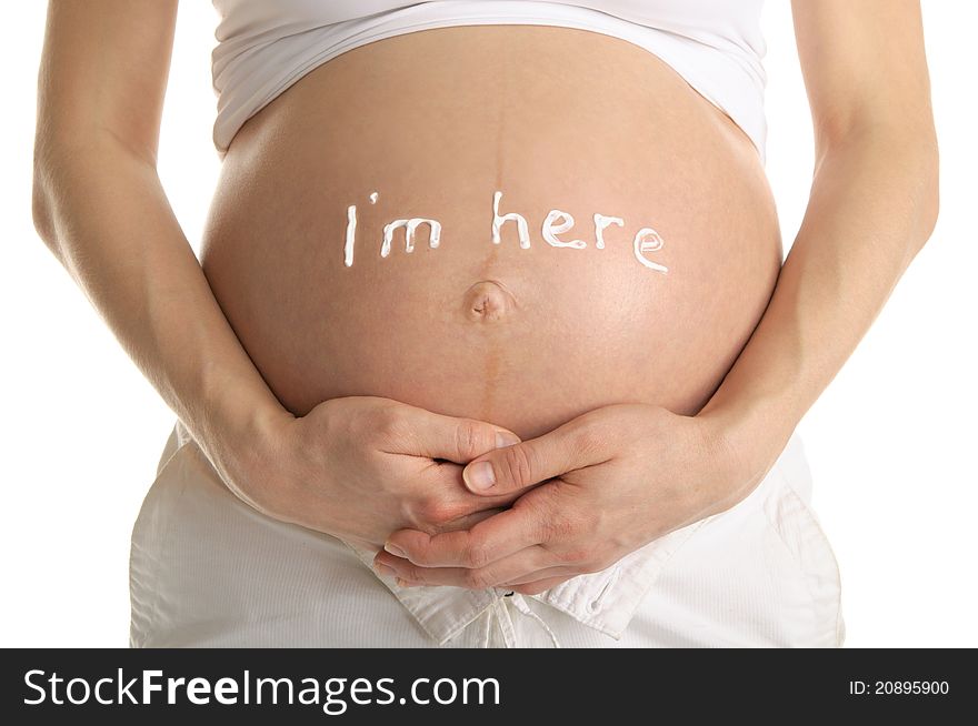 Stomachs of pregnant woman with the inscription I m here isolated on white. Stomachs of pregnant woman with the inscription I m here isolated on white