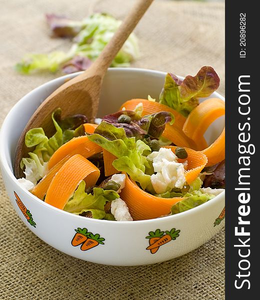 Carrot salad with lettuce and feta cheese. Selective focus