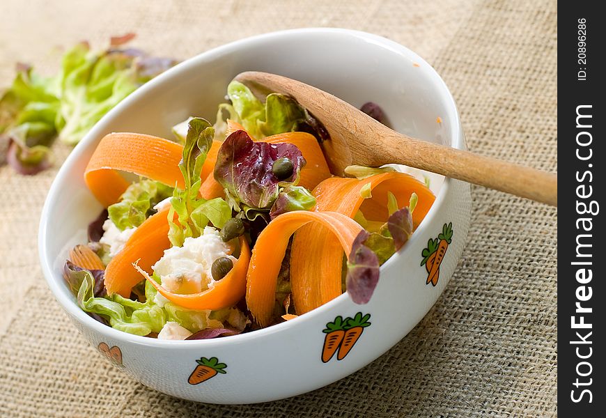 Carrot salad with lettuce and feta cheese. Selective focus