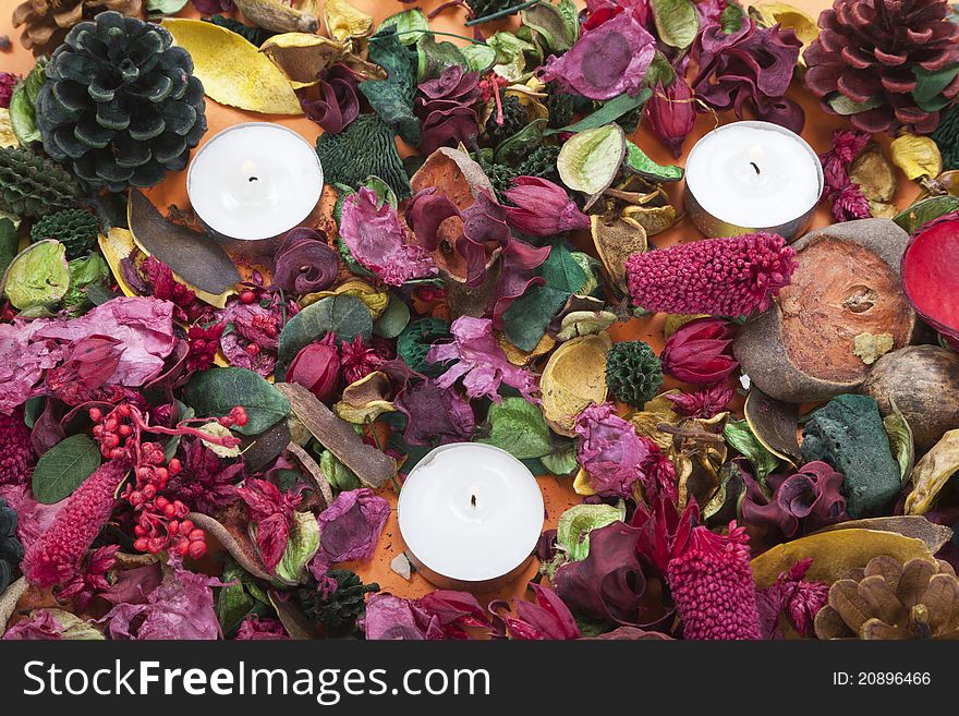 White candles  between aromatic dried flower