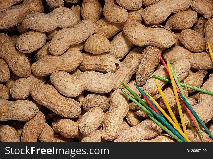 Nuts Peanuts are scattered as a background on a table.