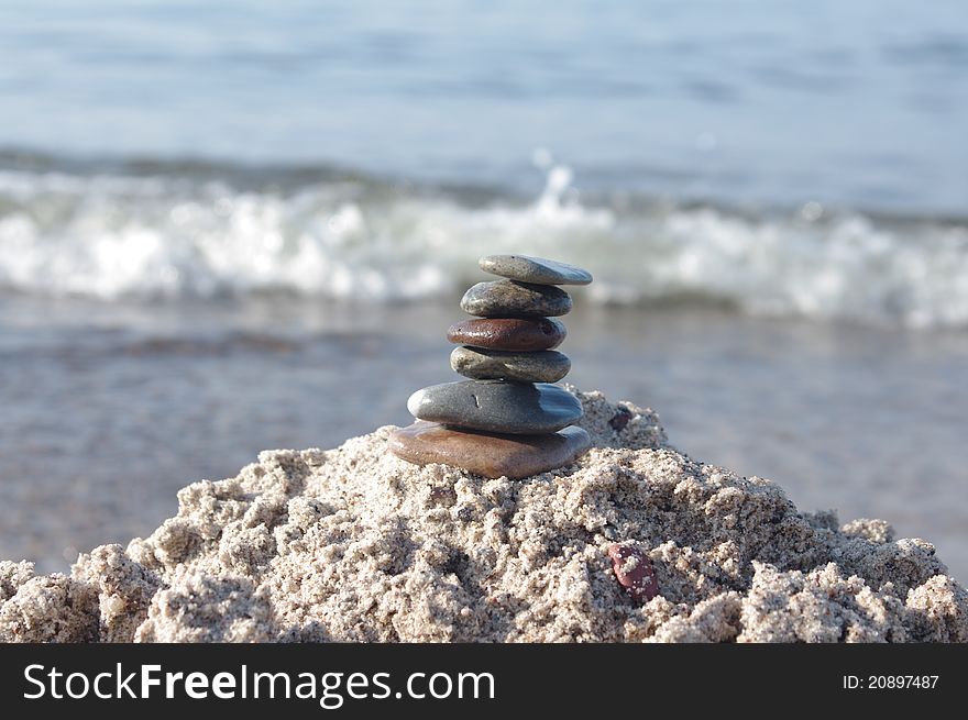 Pyramid with six stones on a white background