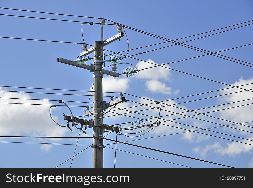 Complex network of electrical power cables isolated against sky background. Complex network of electrical power cables isolated against sky background.