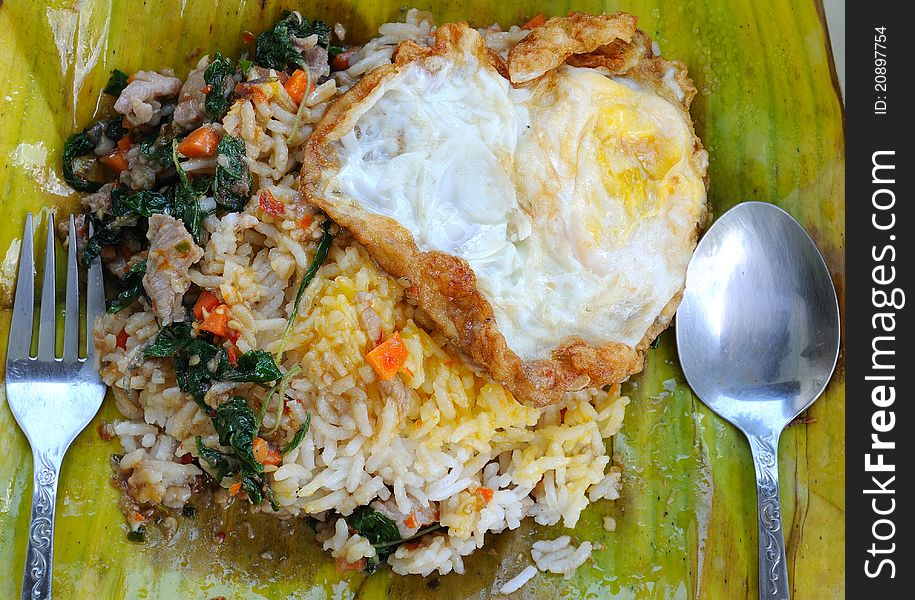 Basil pork with rice on banana leaf in thai style