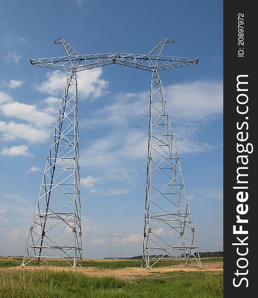 Electrical towers without wires against the blue sky