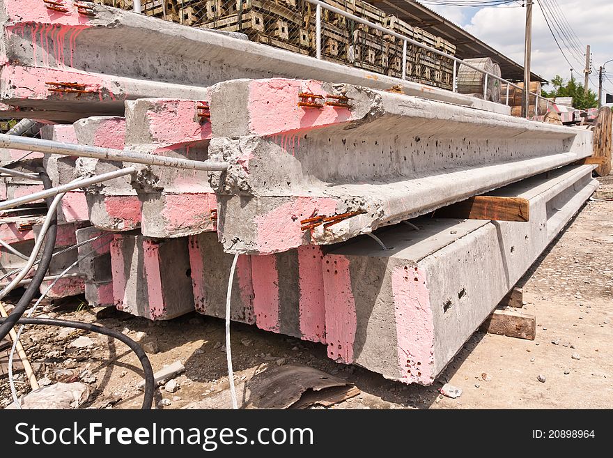 Group of concrete electricity poles stacked on floor close up. Group of concrete electricity poles stacked on floor close up