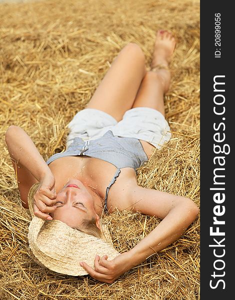 Woman relaxing in hay stack