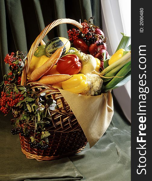 Still-life from vegetables in a basket. Still-life from vegetables in a basket