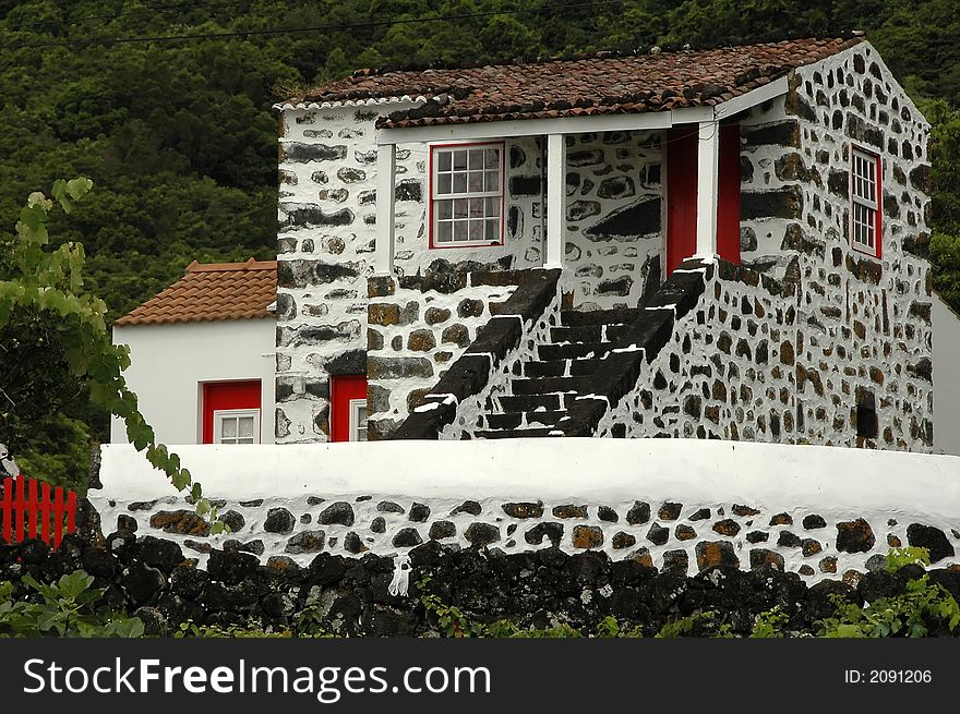Old azores home made of stone and old ceramic roof tiles