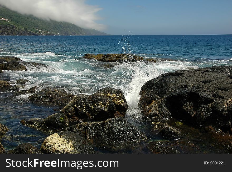 Ocean waves spraying against an Azores Island coastline. Ocean waves spraying against an Azores Island coastline