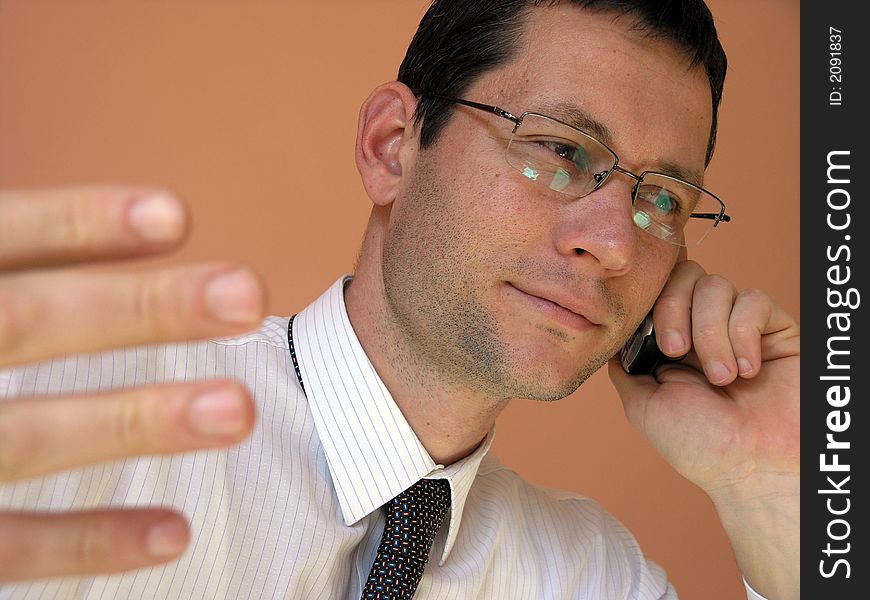 Business call.Young businessman talking to the cell phone. Business call.Young businessman talking to the cell phone.