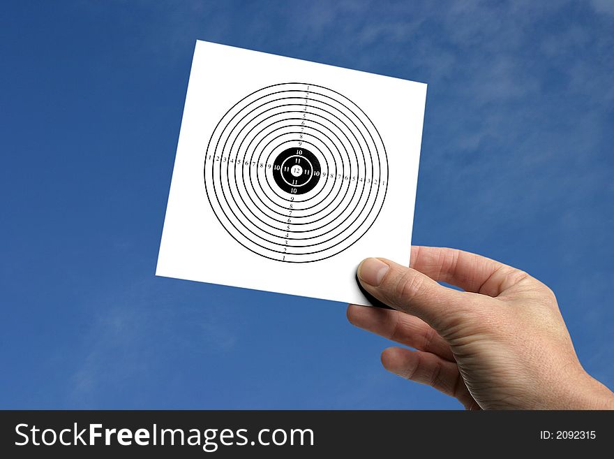 Hand holding a target against a blue sky, get your targets, or reach your goals,please take a look at my other images of targets. Hand holding a target against a blue sky, get your targets, or reach your goals,please take a look at my other images of targets