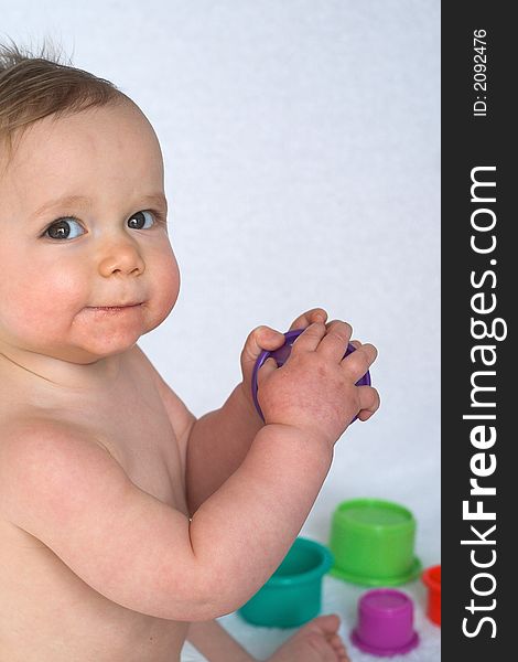 Image of adorable baby playing with stacking cups. Image of adorable baby playing with stacking cups