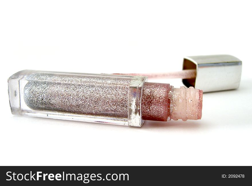 Opened silver gloss for lips on white background