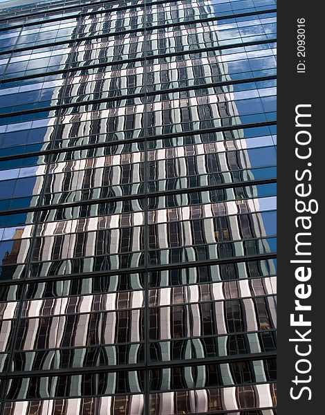 Blue sky reflected in a glass office building. Blue sky reflected in a glass office building