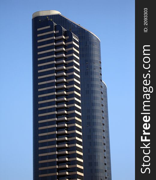 Modern skyscrapers against a bright blue sky