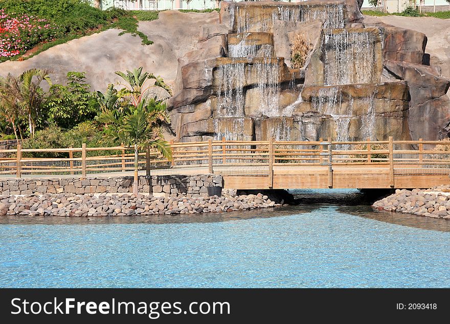 Waterfall and cristal lake in the city garden park