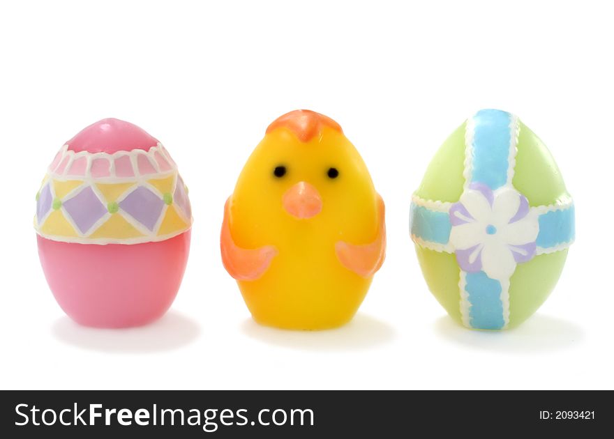 Pastel colored, wax Easter eggs on white background.