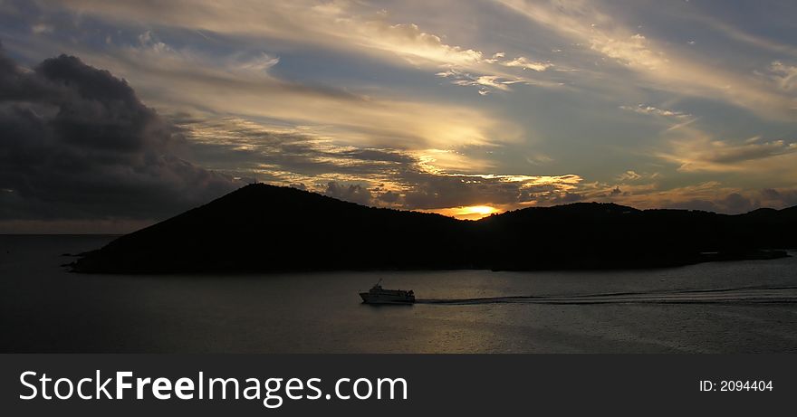 Caribbean island and boat at sunset. Caribbean island and boat at sunset