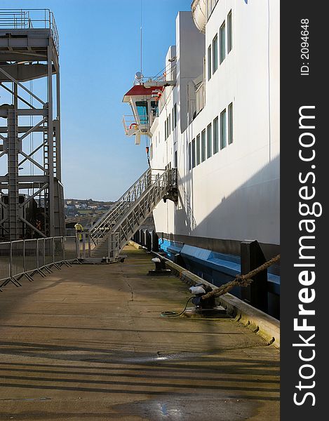 A view down the pier of the old fashioned gangway in use for foot passengers to access the ferry. A view down the pier of the old fashioned gangway in use for foot passengers to access the ferry.