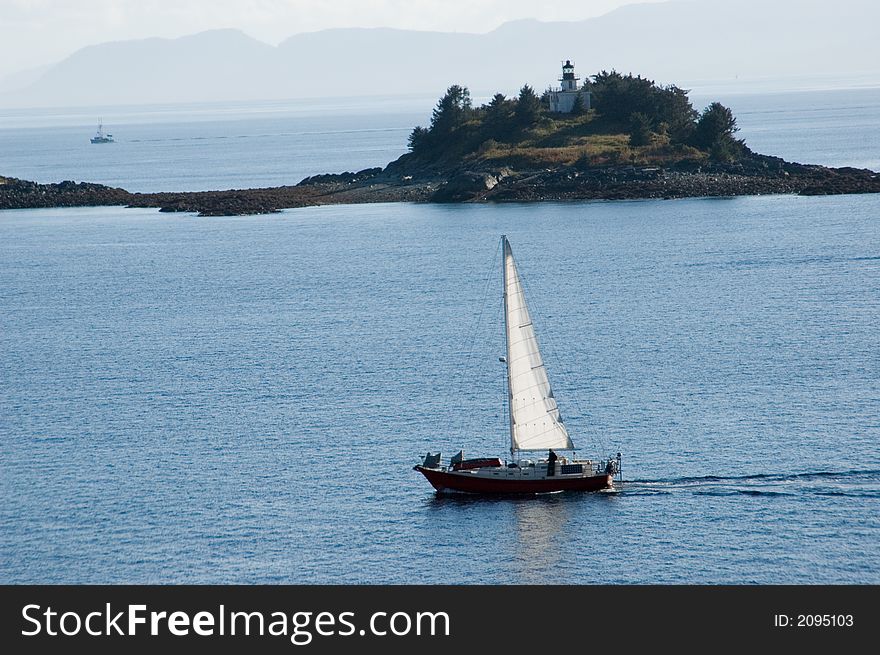 Sailboat Near Island Lighthouse