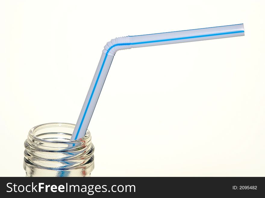 Isolated clear soda bottle and blue striped straw. Isolated clear soda bottle and blue striped straw.