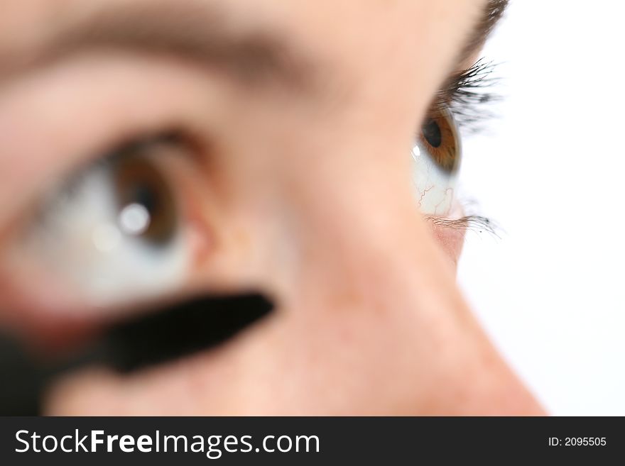 Closeup of a woman applying mascara