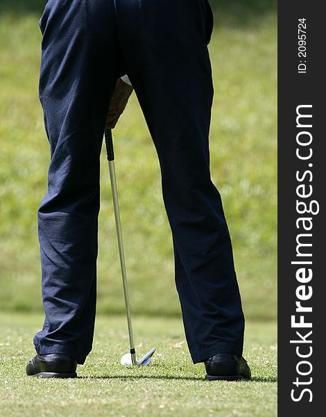 A golfer playing golf in the field.