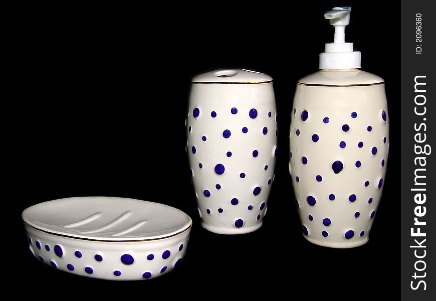 White soap dish set with blue circles on black background
