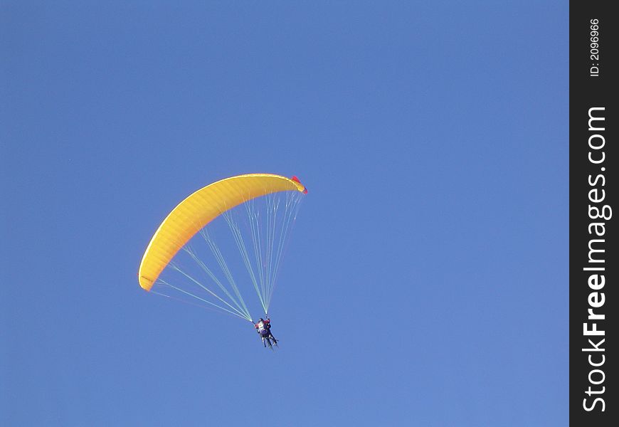 Paraglider on clear blue sky. Paraglider on clear blue sky