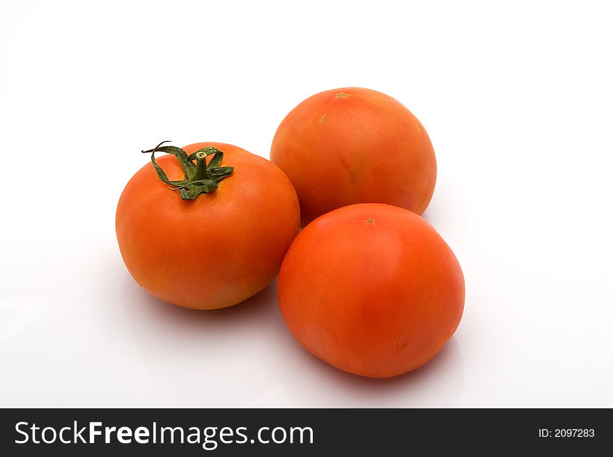 Three isolated tomatoes