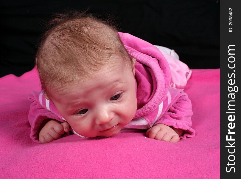 A little baby girl posing for a picture