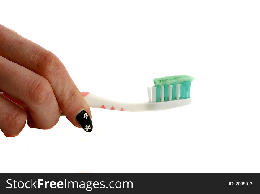 Woman's hand holding a toothbrush with toothpaste. Woman's hand holding a toothbrush with toothpaste