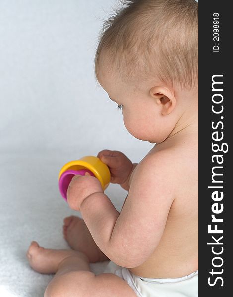 Image of adorable baby playing with stacking cups. Image of adorable baby playing with stacking cups