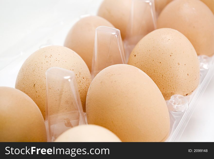 Closeup of organic fresh eggs in a plastic recipient