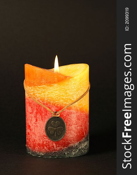 The fragranced irish candle shot on a black background. The fragranced irish candle shot on a black background