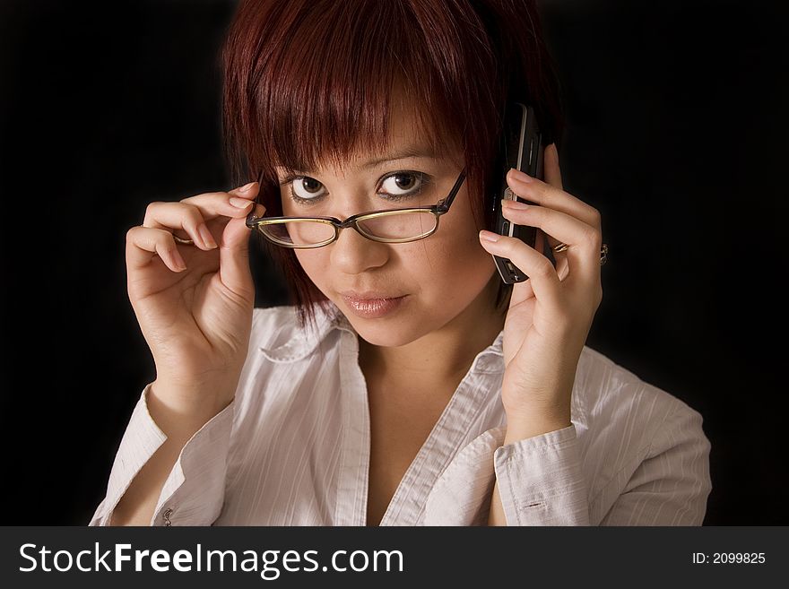 asian office girl taking a very important business call. asian office girl taking a very important business call