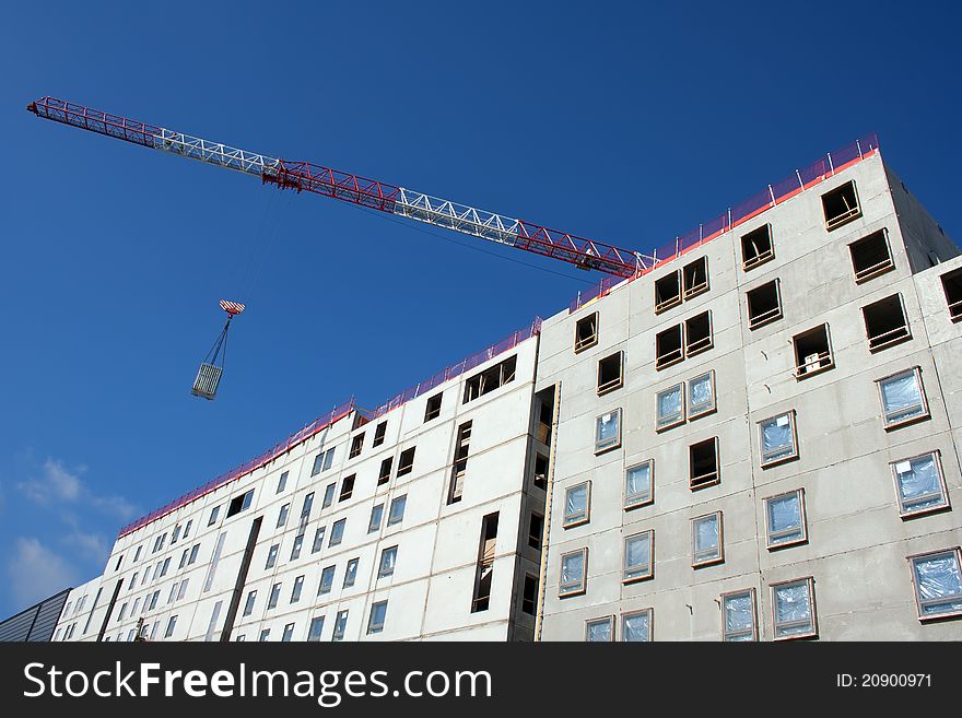Apartment construction site with blue sky and crane. Apartment construction site with blue sky and crane