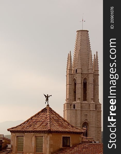 Spire of st Feliu church and roof with weather vane, Girona, Spain. Spire of st Feliu church and roof with weather vane, Girona, Spain