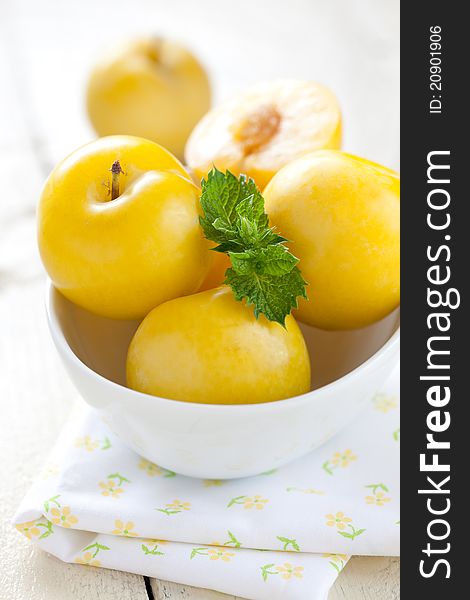 Ripe yellow plums in bowl