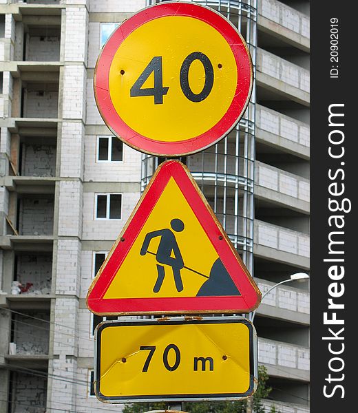 Under construction road sign on building