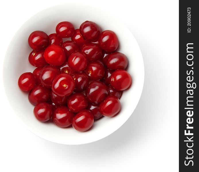 Handful of red cherries in a plate on a white background. Handful of red cherries in a plate on a white background