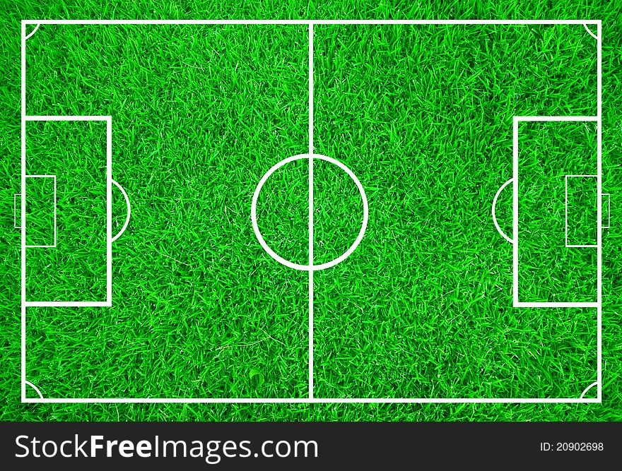 Soccer field with white lines on green grass